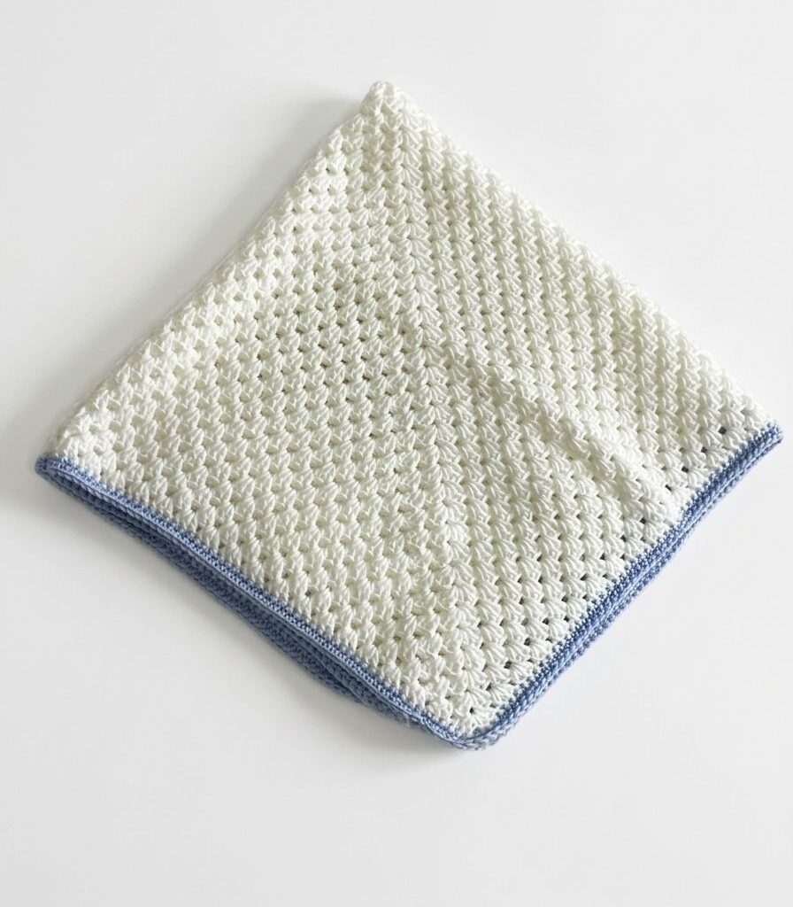 WhatsApp Image 2026-04-17 at 11.02.17 AM Handmade White Crochet Baby Blanket with Blue Edge – Soft & Elegant Design
